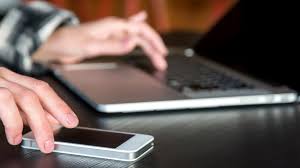 Person multitasking with smartphone, reducing attention span